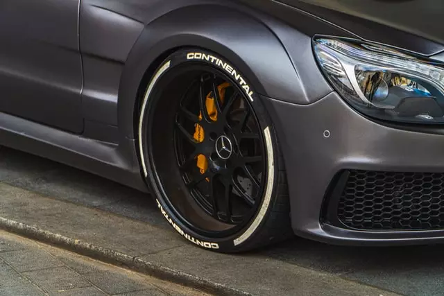 Grey Car With Black Wheel and Yellow Caliper